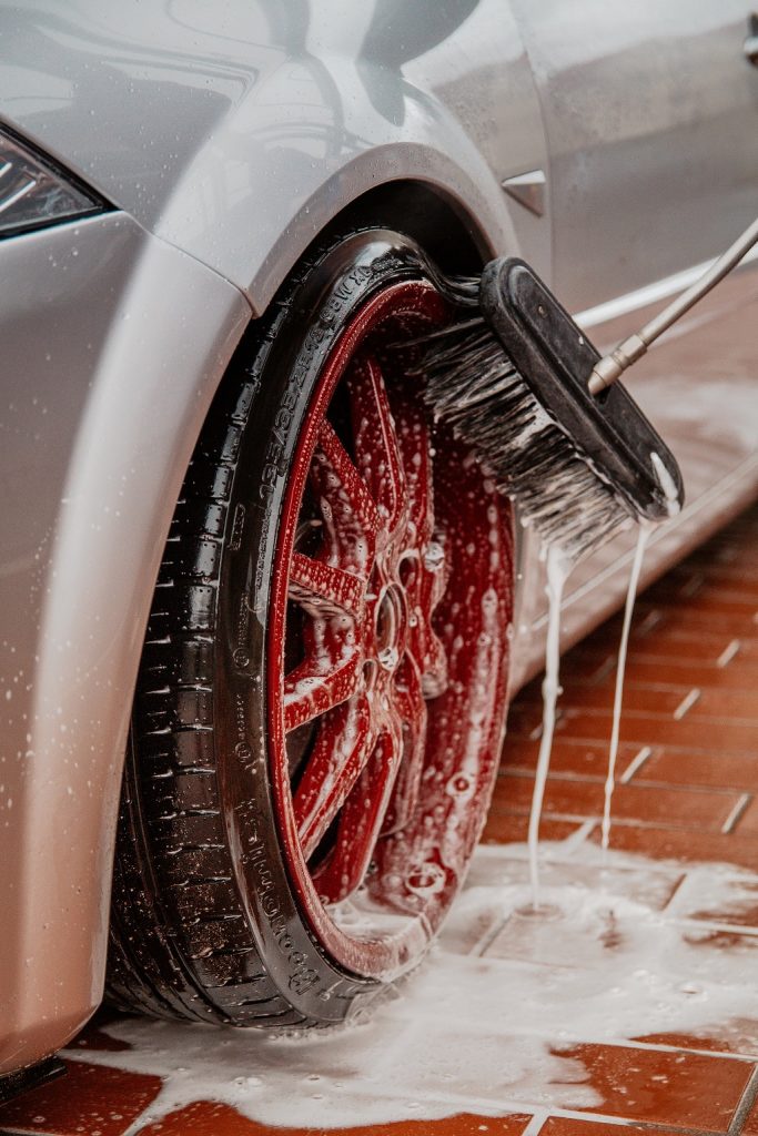 Washing car wheel with mop