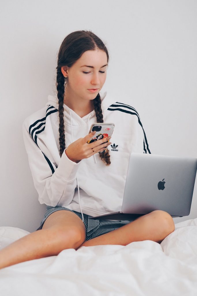 Student girl typing something and looking for some information.