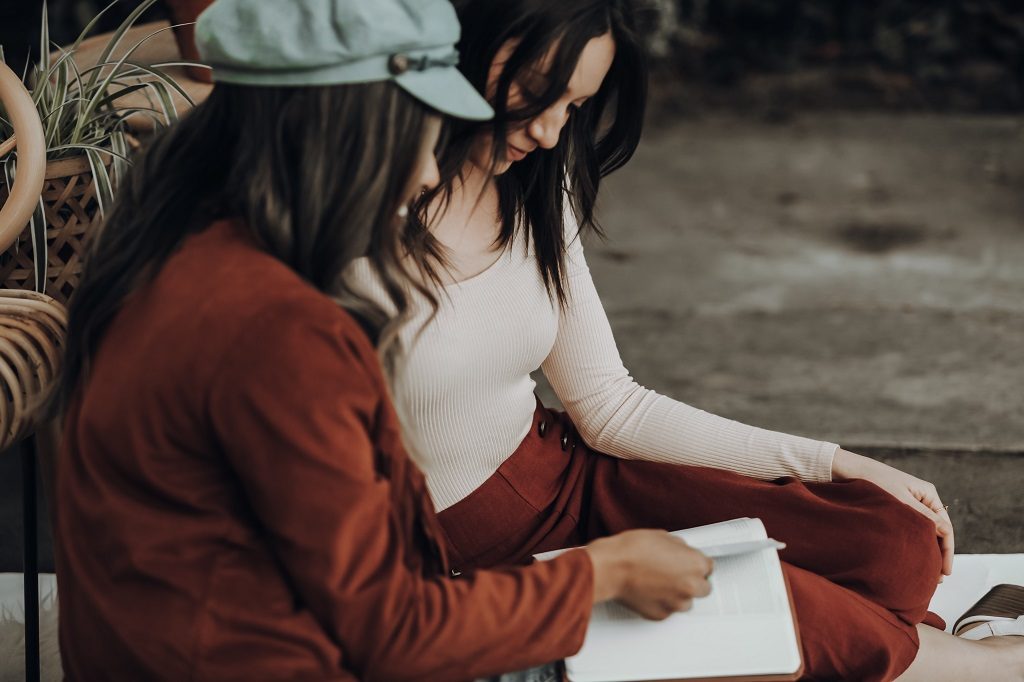 Two girl students discussing somerhing about research